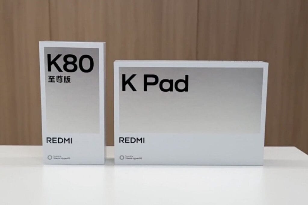 Redmi K Pad: 8.8″ 3K Display, 165Hz Refresh Rate, and Dimensity 9400+ Two white product boxes on a table. The larger box displays 'Redmi K Pad' in black sans-serif font. The smaller box shows 'Redmi K80' and '至尊版' (meaning 'Supreme Edition' in Chinese) in black sans-serif font.