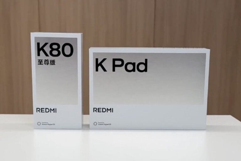 Redmi K Pad: 8.8″ 3K Display, 165Hz Refresh Rate, and Dimensity 9400+ Two white product boxes on a table. The larger box displays 'Redmi K Pad' in black sans-serif font. The smaller box shows 'Redmi K80' and '至尊版' (meaning 'Supreme Edition' in Chinese) in black sans-serif font.