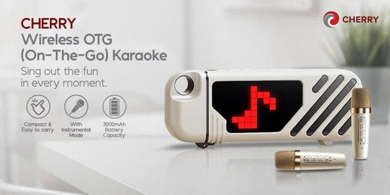 CHERRY Philippines Launches Portable Wireless OTG Karaoke System Product shot of the CHERRY Wireless OTG (On-The-Go) Karaoke machine. The device is light beige/gold, compact, and rectangular with a red LED musical note display. Two gold wireless microphones are included. Features highlighted include portability, a 3000mAh battery, and an instrumental mode.
