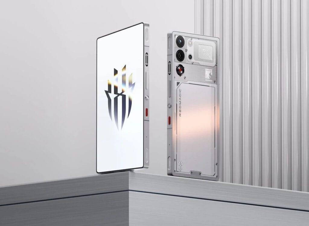 Redmagic 11 Pro Spotted on Geekbench with Snapdragon 8 Gen 5? 1 Close-up of two Redmagic 11 Pro smartphones, one with a white screen displaying the Redmagic logo, the other showing the transparent, tech-inspired back design with visible components and branding.