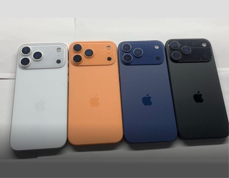 A lineup of iPhone 17 Pro dummy models in various colors, including white, orange, blue, and black. The image highlights the distinctive horizontal camera arrangement on the rear.