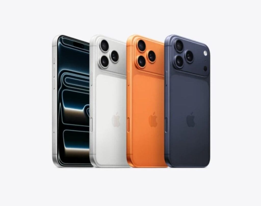 A lineup of four iPhone 17 Pro Max models in silver, white, cosmic orange, and deep blue, showcasing the rear camera array and sleek design.