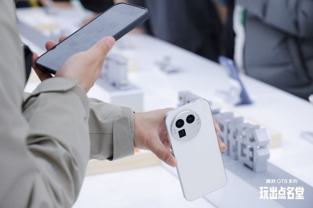 Realme GT 8 Debuts in China with Premium Design and Specs 1 Close-up of a white Realme GT 8 being held by a hand, highlighting its camera design and sleek finish.