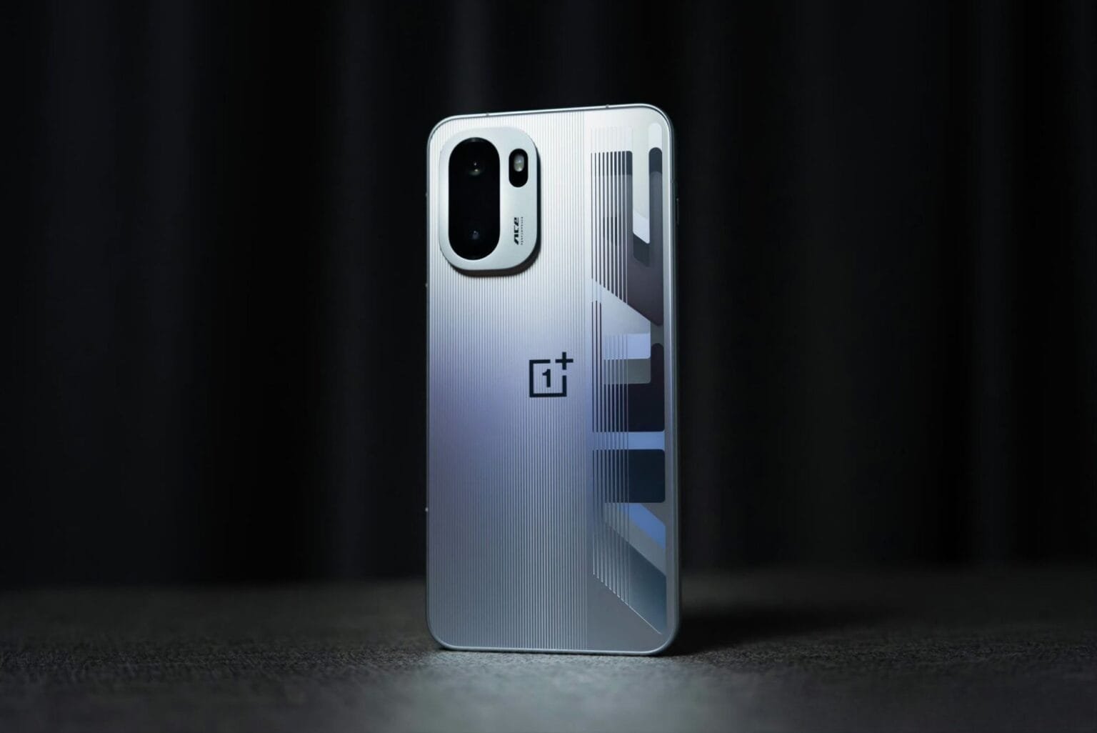 OnePlus Ace 6 Turbo Rumors Surface: Key Details Leaked Silver OnePlus Ace 6 Turbo with a ridged back, showcasing its camera module, logo, and geometric design.