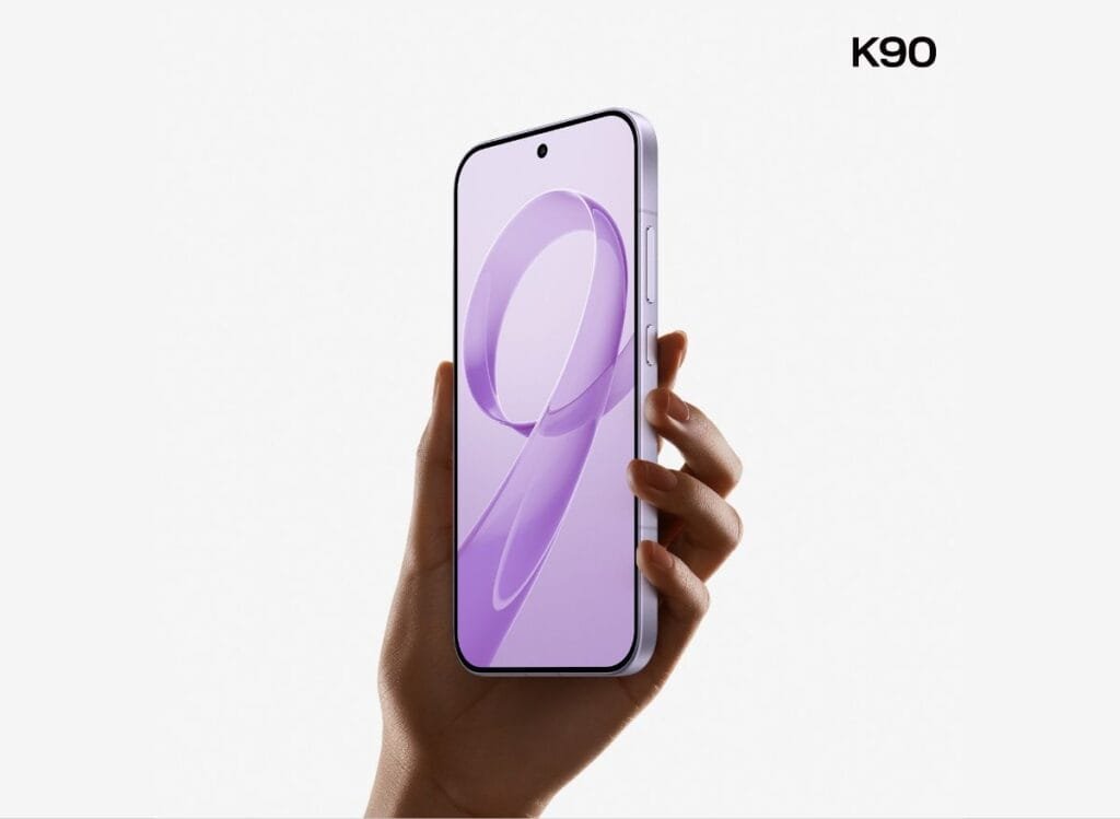 The Redmi K90 in hand, highlighting its slim profile, minimalist button placement, and vibrant screen with a flowing lavender graphic.