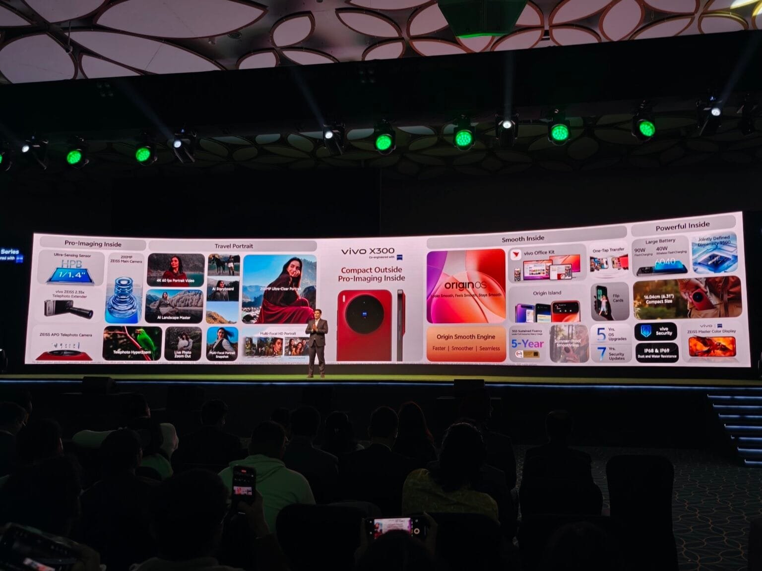 vivo X300 series launch event in India, with a presenter on stage and the phone's features displayed on a large screen.