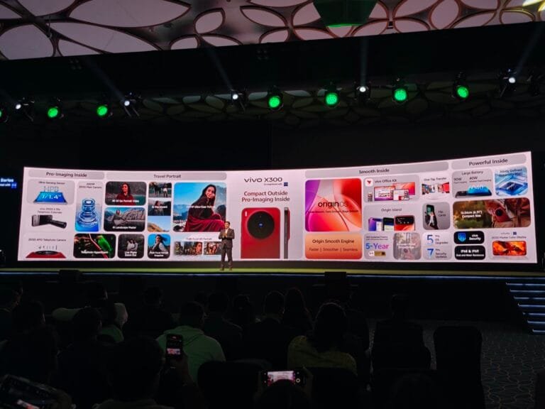 Vivo X300 Launched in India with Starting Price of ₹75,999 vivo X300 series launch event in India, with a presenter on stage and the phone's features displayed on a large screen.