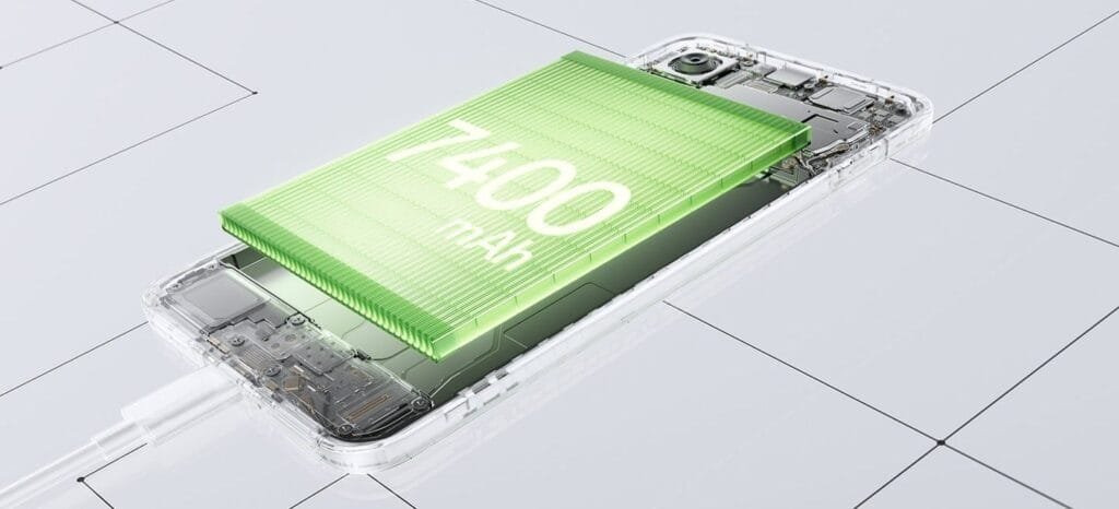Close-up of the OnePlus 15R's internal components, showcasing a large, green 7400 mAh battery. The phone has a transparent design, with a charging cable visible.