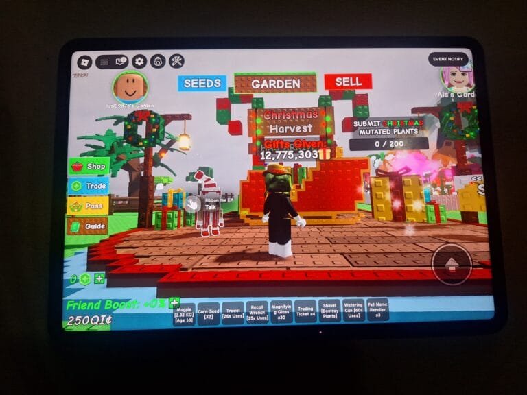 Screenshot from Grow a Garden showing the Christmas Harvest event area with gifts and an elf character.