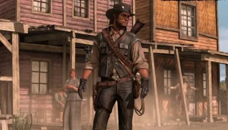 Screenshot of John Marston standing in front of a wooden building in Red Dead Redemption.