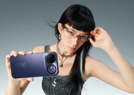 A person with glasses holds up a Huawei Nova 15 Ultra, showcasing its camera design.
