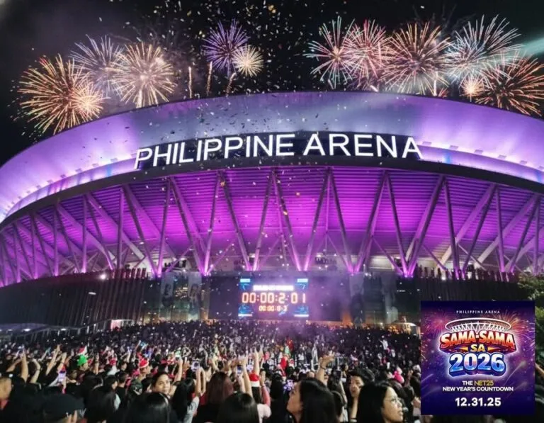 A large crowd gathers in front of the Philippine Arena, which is illuminated in purple, during a New Year’s countdown event. Fireworks burst in the night sky above the arena, and a digital timer shows '00:00:20.1'. A graphic overlay in the bottom right corner reads 'Philippine Arena Sama-Sama Sa 2026 – The NET25 New Year’s Countdown 12.31.25'.