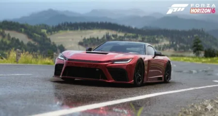 A red 2025 GR GT – the cover car for Forza Horizon 6 – drives on a wet asphalt road. The background features rolling green hills, dense forests, and misty mountains under a light blue sky. The Forza Horizon 6 logo is displayed in the top right corner.
