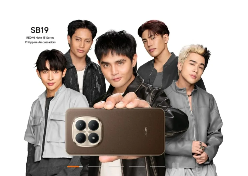 Redmi Note 15 Series to Arrive in the Philippines Featuring New Ambassadors SB19 Filipino boy group SB19, named as Philippine Ambassadors for the Redmi Note 15 Series, pose together against a white background. One member holds up a brown Redmi Note 15 smartphone, displaying its quad-camera module with a metallic frame. Text in the top-left corner reads: 'SB19 – REDMI Note 15 Series Philippine Ambassadors'.
