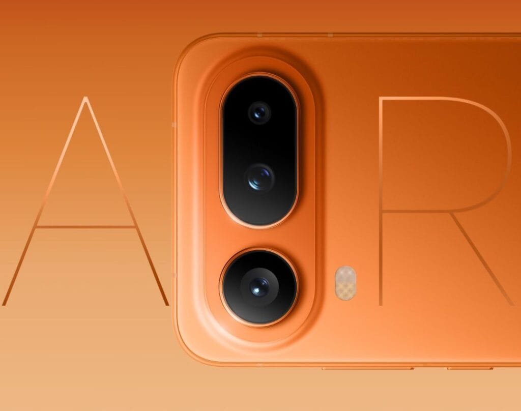 Close-up of the orange Honor Magic 8 Pro Air smartphone's rear camera module and back panel, featuring three camera lenses in a vertical layout and stylized 'A' and 'R' lettering in the background.