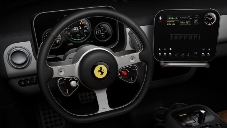 Ferrari Luce interior cockpit: Black leather-wrapped steering wheel with iconic prancing horse emblem, integrated controls, and red engine start button. Behind it, a multi-gauge digital instrument cluster displays speed (210 km/h), range, and vehicle data. To the right, a large central touchscreen shows performance metrics (464 kW power) and the Ferrari logo, with climate and connectivity controls below.