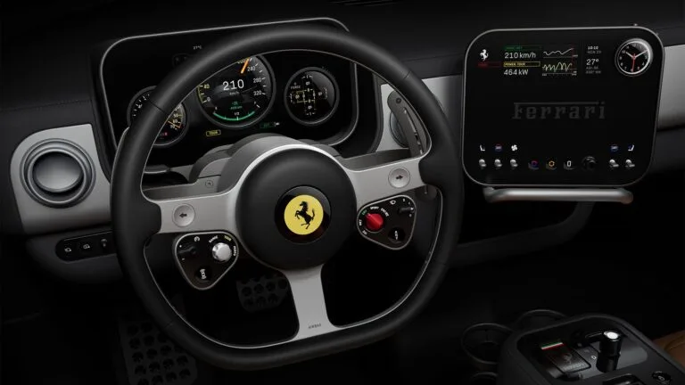 Ferrari Luce Interior Revealed: First Look at the Electric Supercar Ferrari Luce interior cockpit: Black leather-wrapped steering wheel with iconic prancing horse emblem, integrated controls, and red engine start button. Behind it, a multi-gauge digital instrument cluster displays speed (210 km/h), range, and vehicle data. To the right, a large central touchscreen shows performance metrics (464 kW power) and the Ferrari logo, with climate and connectivity controls below.