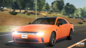 An orange modern muscle car driving on a paved road through a hilly, sunlit landscape. The car has its headlights on, a black roof, and a California license plate reading "1EWO164." The words "MOJAVE VALLEY" are visible in the bottom right corner.
