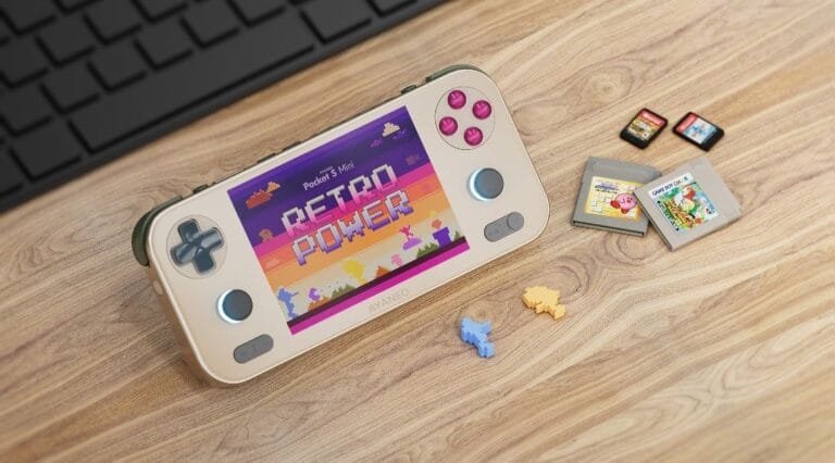Ayaneo Pocket S Mini handheld gaming device in Retro Power colorway, displaying 'Retro Power' on its screen, placed on a wooden surface with game cartridges and small puzzle pieces nearby.