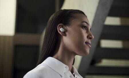 Sony Launches WF-1000XM6, WH-1000XM6 Worldwide Starting PHP 18,999 Side profile of a person wearing Sony WF-1000XM6 true wireless earbuds in white, highlighting the compact design in a modern indoor setting.