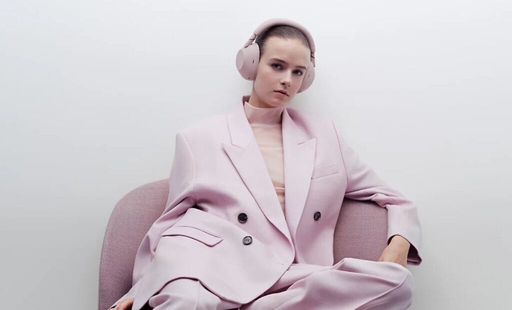 Sony Launches WF-1000XM6, WH-1000XM6 Worldwide Starting PHP 18,999 2 Side profile of a person wearing Sony WF-1000XM6 true wireless earbuds in white, highlighting the compact design in a modern indoor setting.