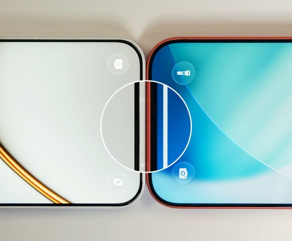 Close-up of two smartphones placed side by side, focusing on their adjacent display edges. One has a light-colored screen with a gold accent line; the other features a blue gradient screen. A white circle highlights the thin gap between the devices.