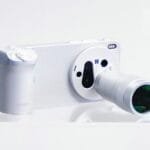 White Vivo X300 Ultra smartphone paired with a dedicated camera grip and external telephoto lens attachment, showcasing a camera-like form factor against a plain white background.