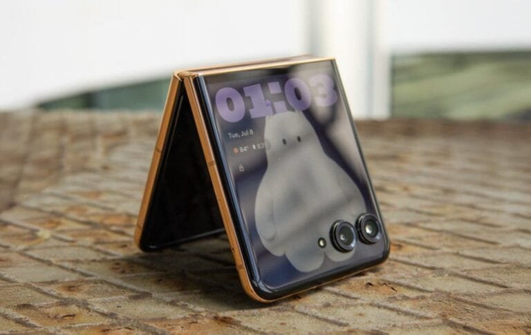 Motorola Razr 70 foldable smartphone partially folded in tent mode, showing its external OLED display with dual rear cameras on the cover panel.