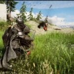 Gameplay scene from Crimson Desert shown at The Game Awards – a heavily armored character in dark gear crouches in tall green grass, with other figures and action effects visible on a sunlit, forested hillside in the background.