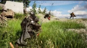 Gameplay scene from Crimson Desert shown at The Game Awards – a heavily armored character in dark gear crouches in tall green grass, with other figures and action effects visible on a sunlit, forested hillside in the background.