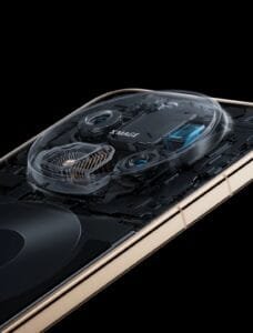 Cutaway view of HUAWEI smartphone’s camera module, revealing internal components and the XMAGE branding. The device has a gold-toned frame, with transparent casing over the camera hardware to showcase engineering design.