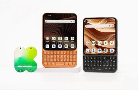 Unihertz Titan 2 Elite smartphone shown in orange and black colors featuring a square display and a physical QWERTY keyboard, displayed beside a Kickstarter logo stand.