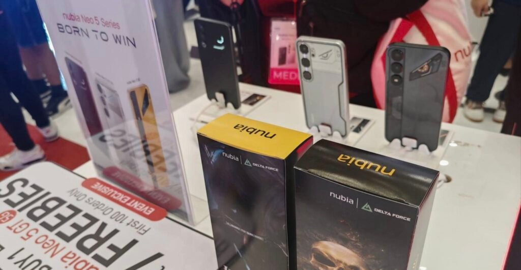 Close-up of nubia Neo 5 Series products at launch event – smartphones on display stands, branded packaging boxes with 'nubia | DELTA FORCE', and promotional signage highlighting 'BORN TO WIN' and event exclusive offers.