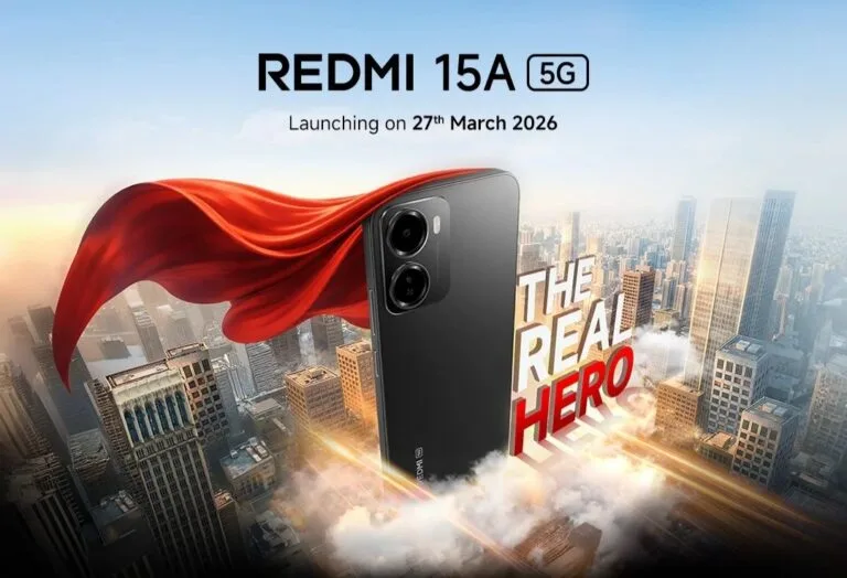 Redmi 15A 5G Teased Ahead of March 27 Launch in India Promotional poster for Redmi 15A 5G. Black smartphone with red superhero cape above a cityscape. Text shows 'Redmi 15A 5G', launch date 27th March 2026, and tagline 'THE REAL HERO'.