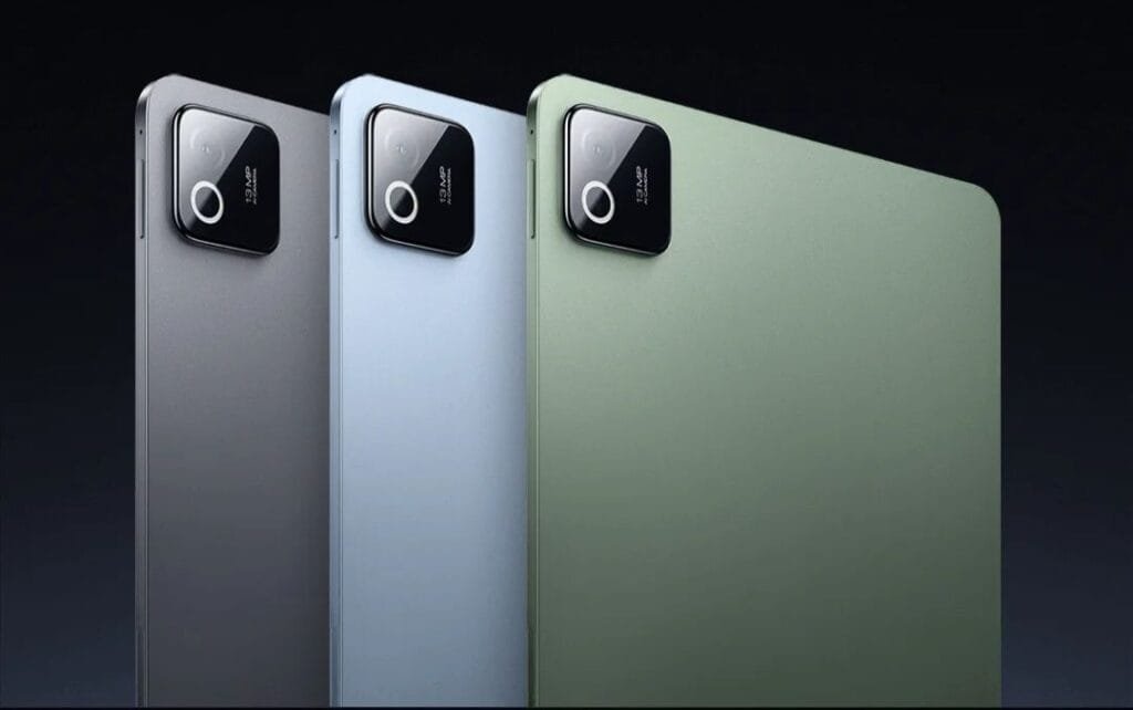 Three Xiaomi tablets shown from the back in silver, light blue, and green colors, featuring a square camera module with a single lens and 13MP label.