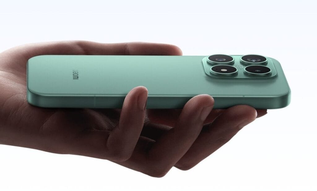 A side-profile view of a mint green Xiaomi 17 being held horizontally in a person's hand. The image highlights the phone's flat edges and the prominent square camera module on the back, which contains four circular lens elements. The Xiaomi logo is visible on the lower half of the rear panel.