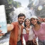 Oppo F33 series smartphone showcased in outdoor adventure setting with friends taking selfie