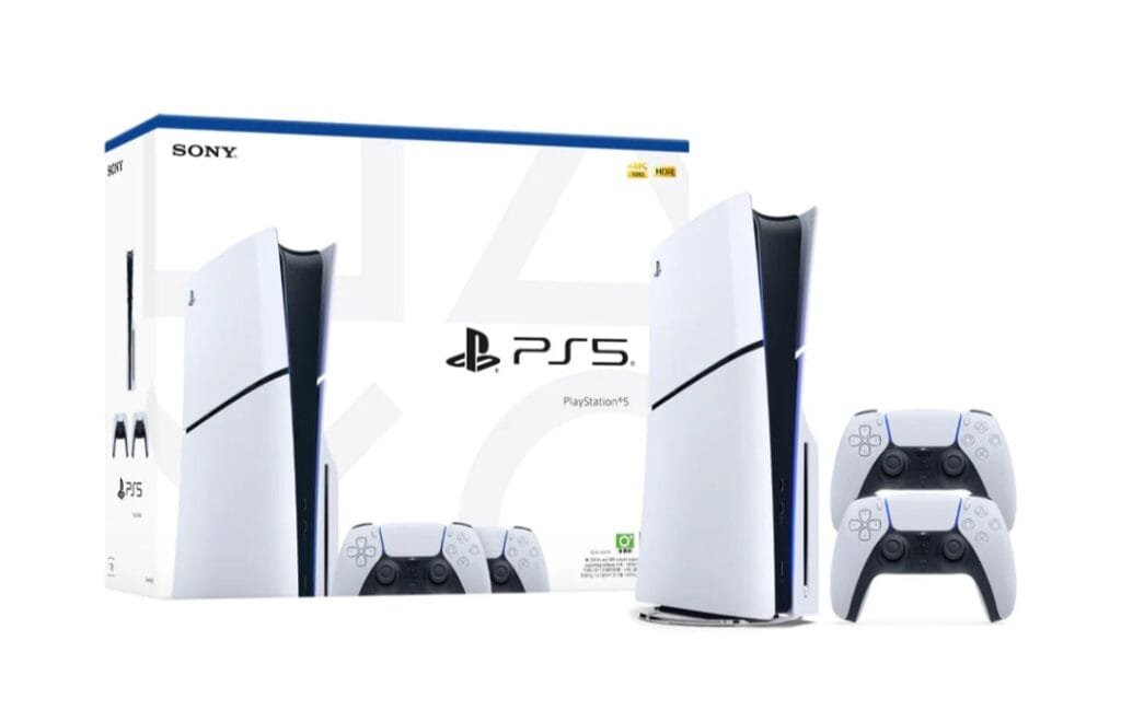 Sony PlayStation 5 console in white and black design, displayed alongside two DualSense wireless controllers and its official retail packaging, set against a plain white background