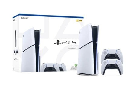 Sony PlayStation 5 console in white and black design, displayed alongside two DualSense wireless controllers and its official retail packaging, set against a plain white background