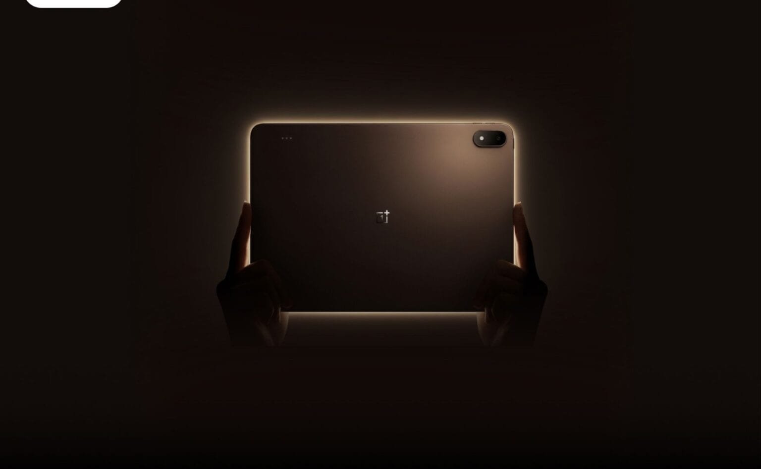 Back view of the OnePlus Pad 4 tablet held by hands, featuring a sleek metallic finish, centered OnePlus logo, and a single camera module in the top right corner, highlighted by a soft glowing outline against a dark background.