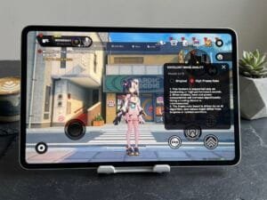 Gaming tablet displaying high frame rate gameplay with on-screen controls and graphics settings menu