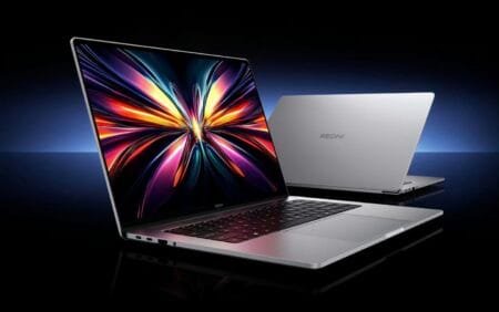 Redmi Book 14 2026 laptop showcased in sleek silver finish, featuring a vibrant display with colorful abstract wallpaper and the Redmi logo clearly visible on the back cover.