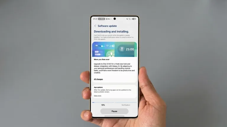 Hand holding Samsung Galaxy phone showing One UI 8.5 software update screen downloading and installing, featuring Galaxy AI integration and new features