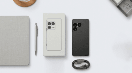 Sony Xperia 1 VIII matte black smartphone shown with original white packaging box and braided USB-C cable, minimalist clean design on light gray background