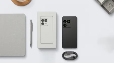 Sony Xperia 1 VIII matte black smartphone shown with original white packaging box and braided USB-C cable, minimalist clean design on light gray background