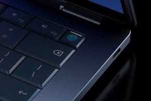 Close-up of Googlebook keyboard area showing F12, F13 keys, a fingerprint sensor integrated into a function key, and a USB‑C port on the chassis edge.