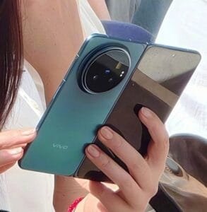 Clear shot of the Vivo X Fold 6 folded, displaying its sleek profile, teal color, and small front camera cutout on the outer screen.