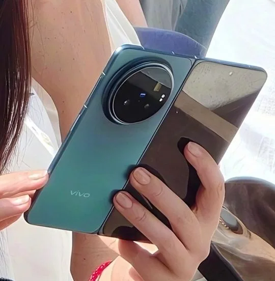Vivo V2545A spotted on Geekbench with MediaTek Dimensity 9500 Clear shot of the Vivo X Fold 6 folded, displaying its sleek profile, teal color, and small front camera cutout on the outer screen.