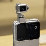 Honor Robot Phone Spotted at China's 3C Certification With 120W Fast Charging 1 Close-up view of the Honor Robot Phone, featuring its distinctive pop-out, multi-axis robotic gimbal camera module mounted on the back of the device, with a sleek silver finish and rear camera array visible.