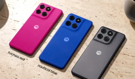 Rear view of the Motorola Moto G77 Power in three color variants: Fuchsia Red, Nautical Blue, and Impenetrable Gray, showing the quad-camera module and centered Motorola logo on a textured matte finish.
